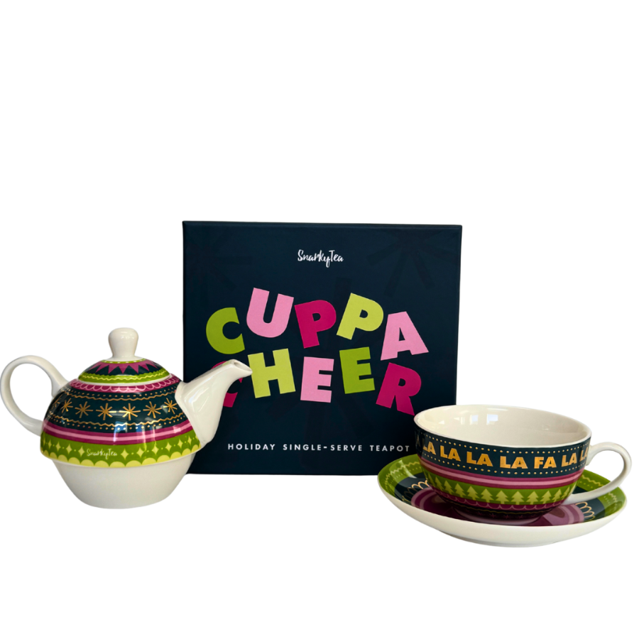 A whitebox photo of the Cuppa Cheer nesting teapot next to it's giftable box that says "Cuppa Cheer"