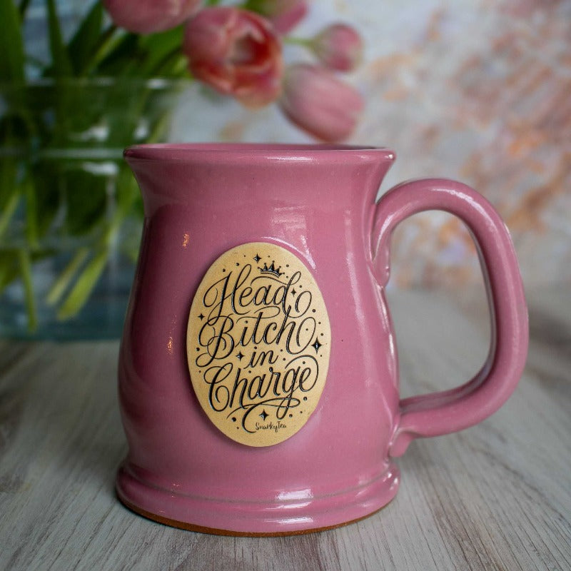 A whitebox photo of the Head Bitch In Charge pink mug