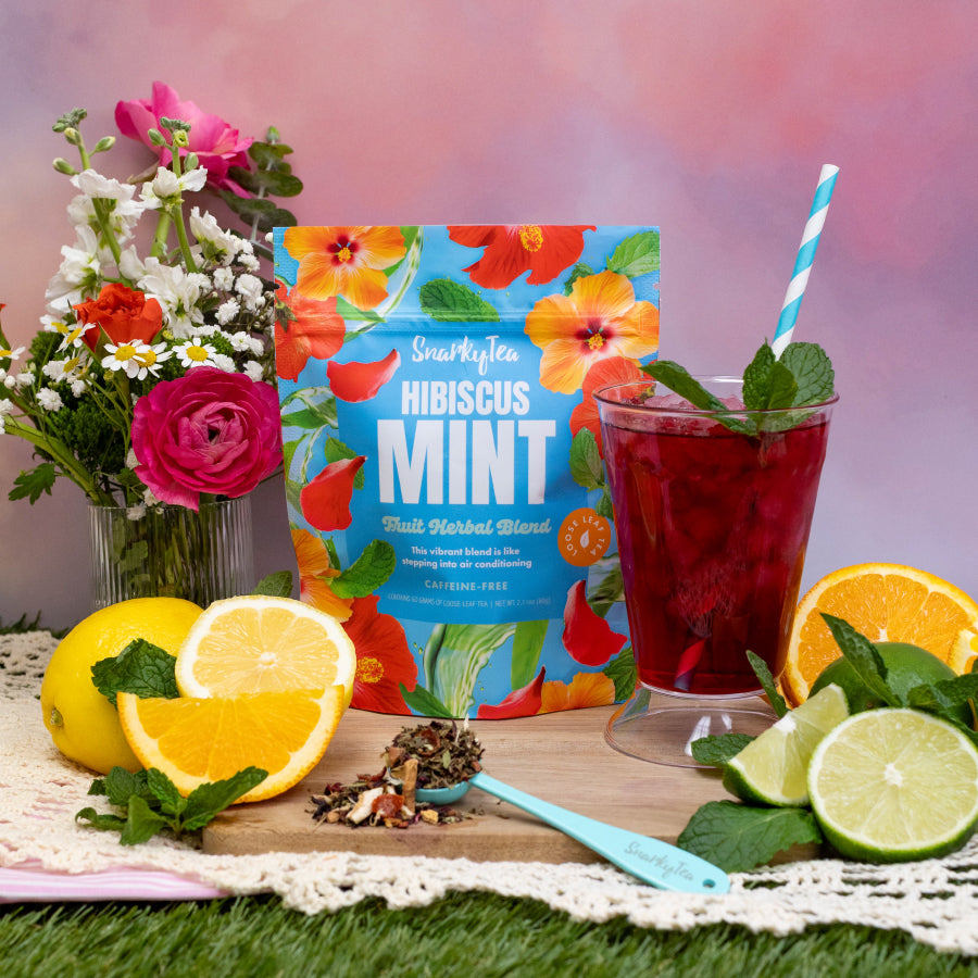 Snarky Tea Hibiscus Mint fruit herbal blend packaging with colorful flowers on a blue background