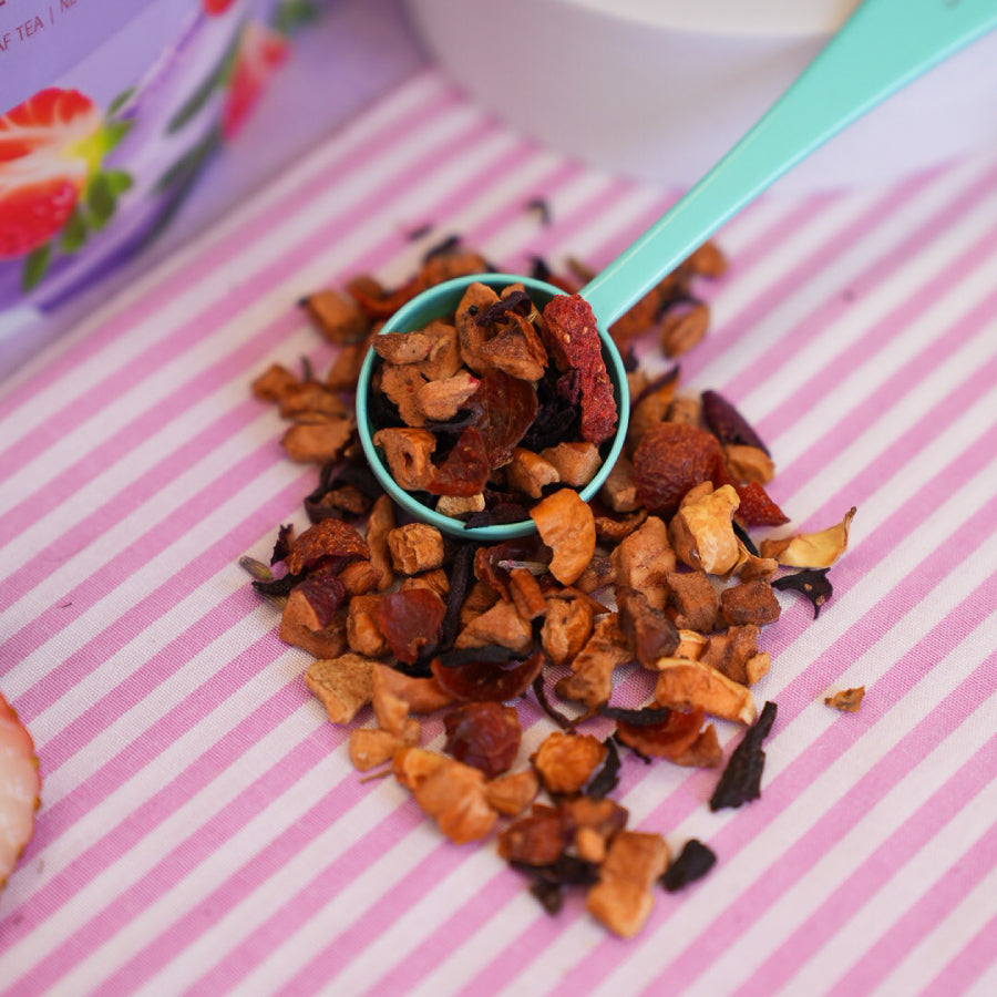 Lavender Berry Packaging for 60 gram bag - adorn with lavender and bright red strawberries. Packaging states that the blend has 60 grams of  loose leaf tea or net weight 2.11 oz. This soothing and sweet blend is berry, bright, and beautifully balanced. 