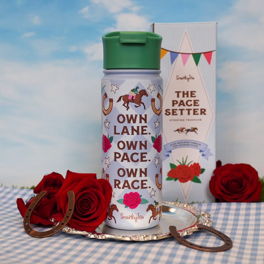 A whitebox photo of the tumbler and it's box, saying "own lane, own race, own pace" and "the pace setter steeping traveler"