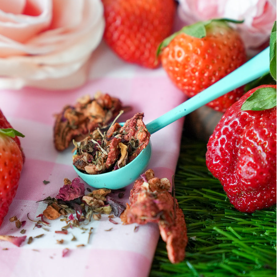 60gram Packaging for 'Strawberry Daydream' fruit herbal blend tea blend by Snarky Tea featuring a pink color scheme with red accents and text detailing.